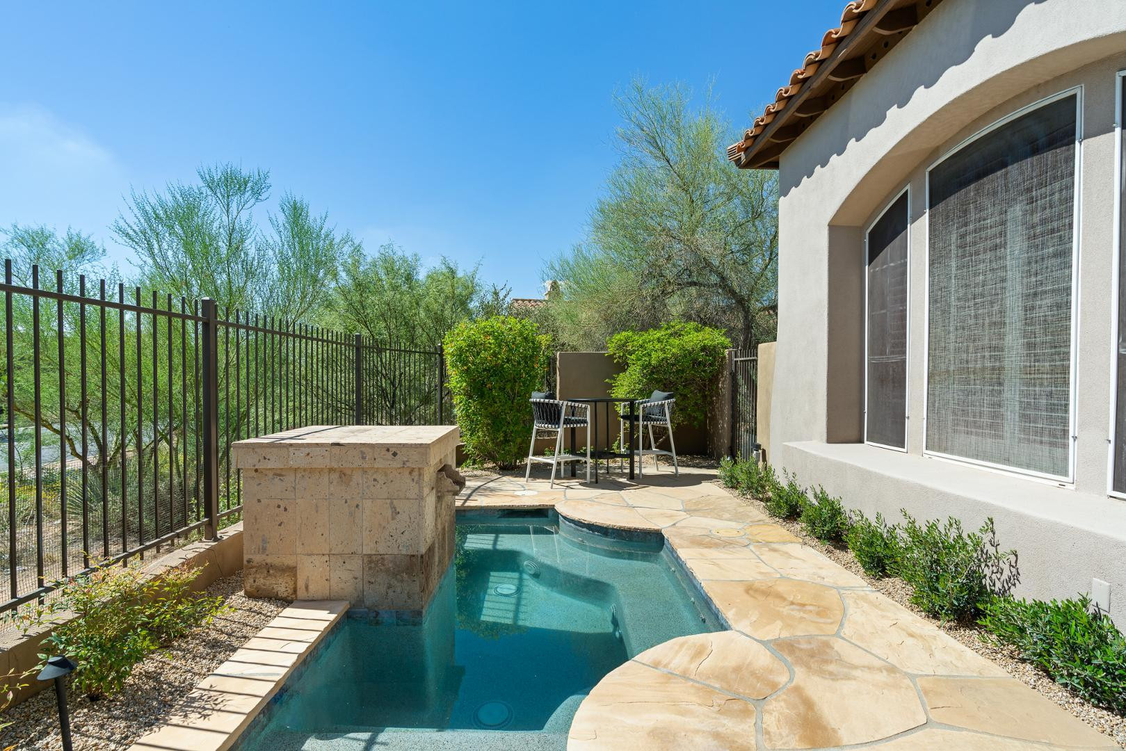 8905 East Mountain Spring Road, Unit 37 Scottsdale, AZ 85255 - Photo 29 of 31 a view of a patio with couches chairs potted plants and palm tree