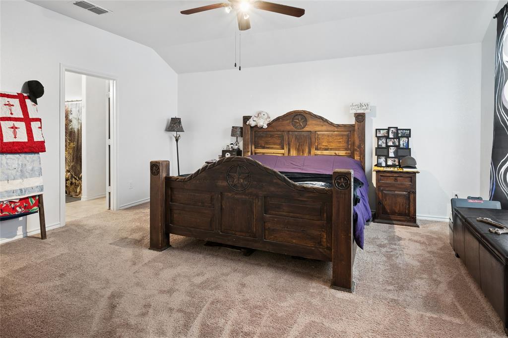 324 Fairgrounds Lane Ponder, TX 76259 - Photo 14 of 40 a bedroom with a bed and a chandelier