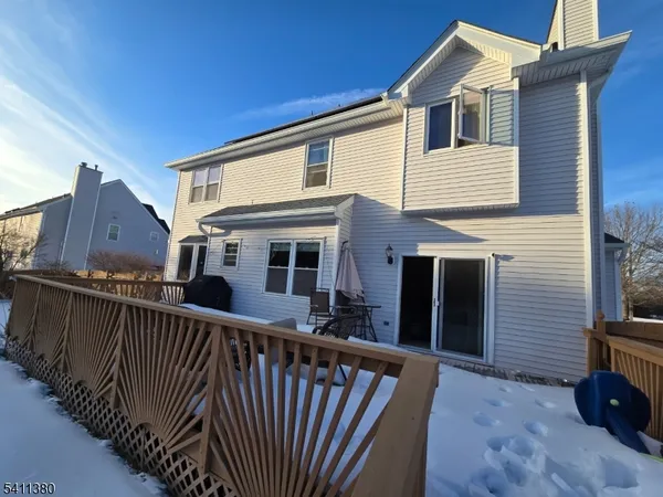 a view of a house with wooden fence