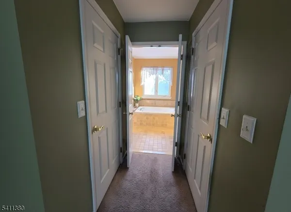 a view of a bathroom from a corridor
