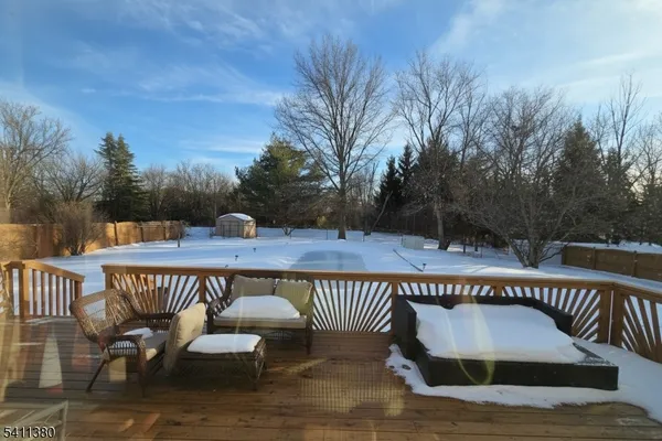 a view of a roof deck with table and chairs and wooden floor