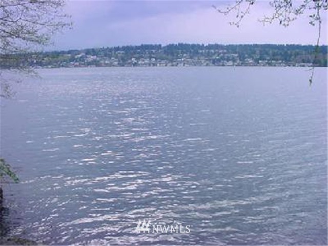 a view of lake with mountain and city in the background