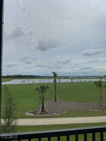 a view of a swimming pool with a yard