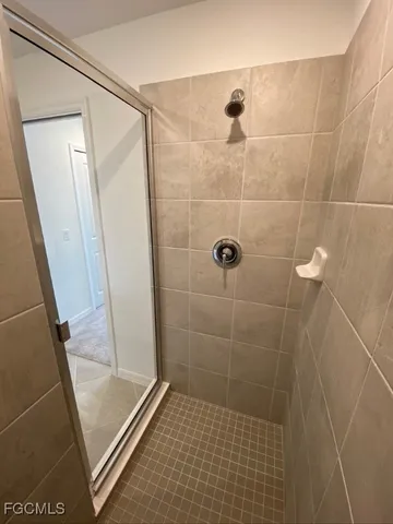 a bathroom with a glass door shower