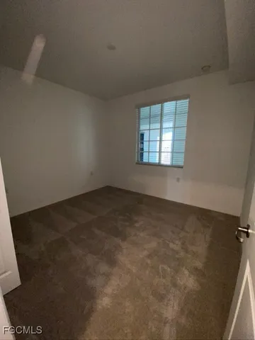 an empty room with a windows
