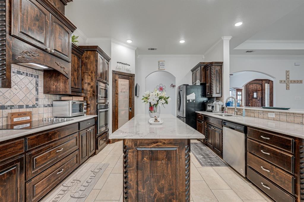1192 Seaborn Road Ponder, TX 76259 - Photo 14 of 40 a kitchen with stainless steel appliances granite countertop a sink stove and refrigerator