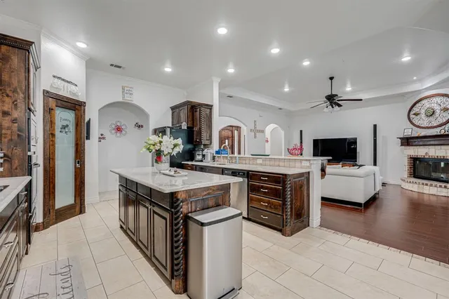 a kitchen with stainless steel appliances granite countertop a sink and dishwasher a stove top oven with wooden floor