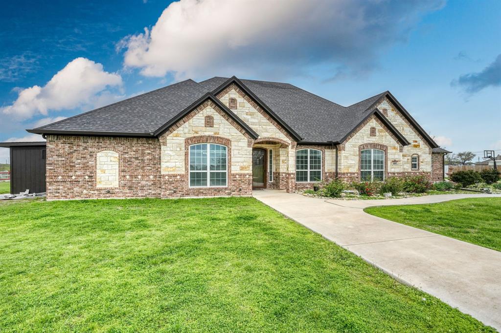 1192 Seaborn Road Ponder, TX 76259 - Photo 2 of 40 a view of a house next to a yard with big trees
