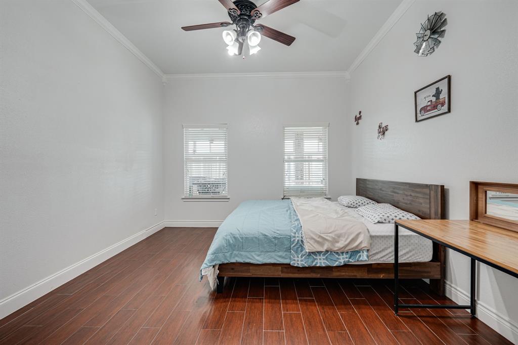 1192 Seaborn Road Ponder, TX 76259 - Photo 23 of 40 a bedroom with a bed and wooden floor