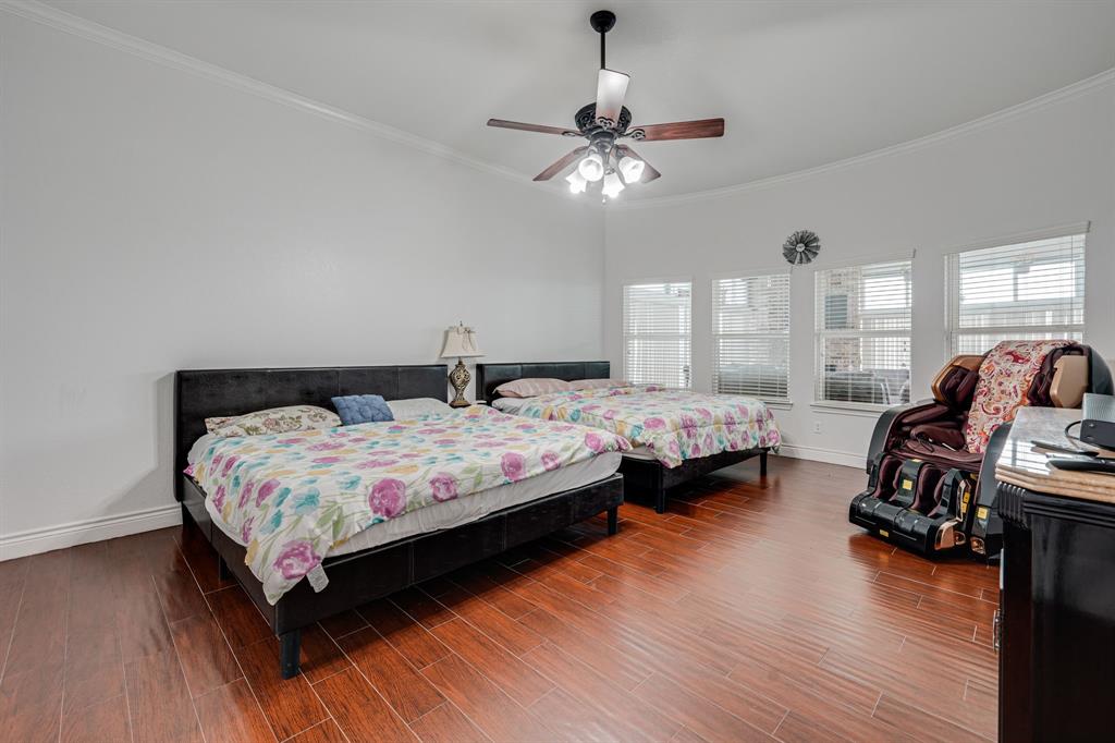 1192 Seaborn Road Ponder, TX 76259 - Photo 24 of 40 a bedroom with a bed a couch and chandelier
