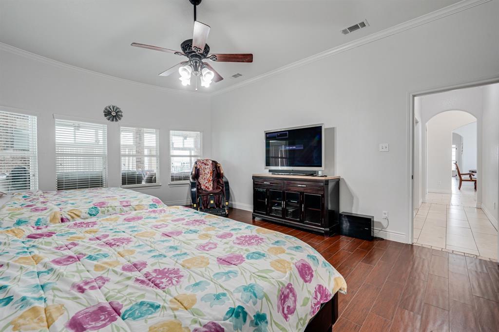 1192 Seaborn Road Ponder, TX 76259 - Photo 25 of 40 a bedroom with a bed and a flat screen tv