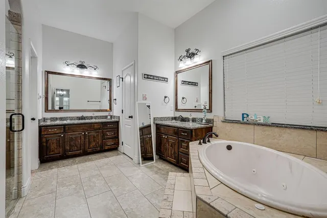 a bathroom with a tub a toilet and a shower