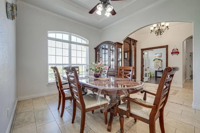 a view of a dining room with furniture and chandelier