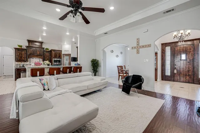 a living room with furniture and a chandelier