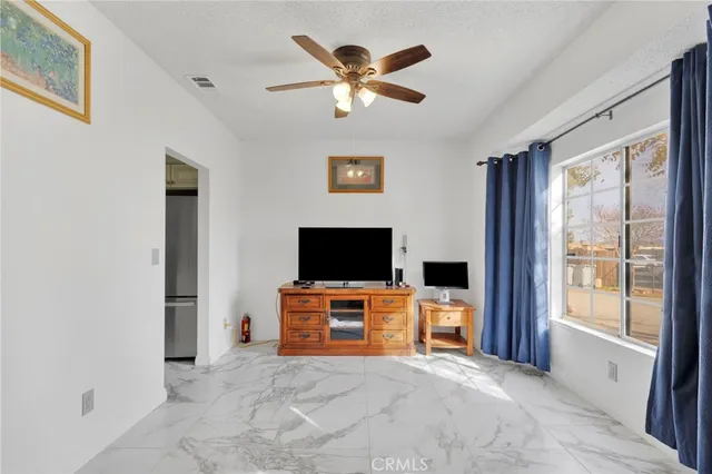 a living room with furniture a rug and a window