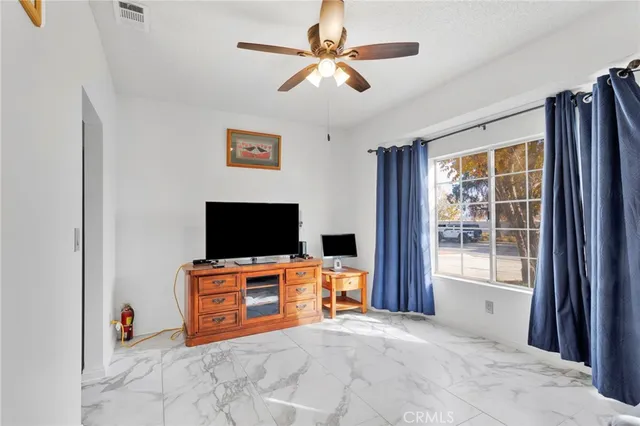 a bathroom with a toilet a sink a mirror and a window