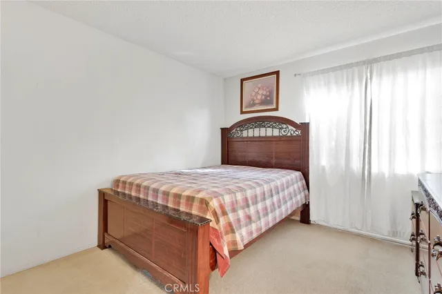 a bedroom with a bed and a lamp