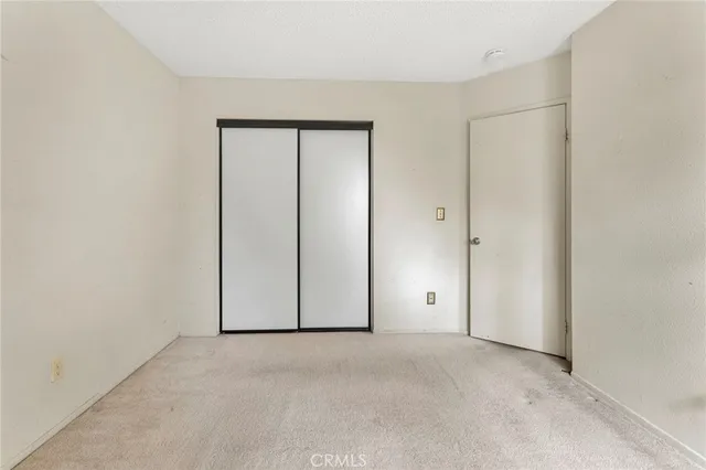 a bathroom with a granite countertop sink toilet mirror and bathtub