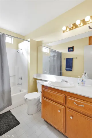 a bedroom with a bed and a large mirror