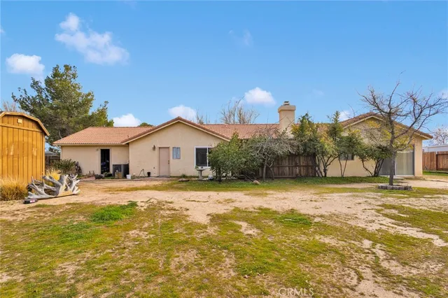 a view of a house with swimming pool and sitting area