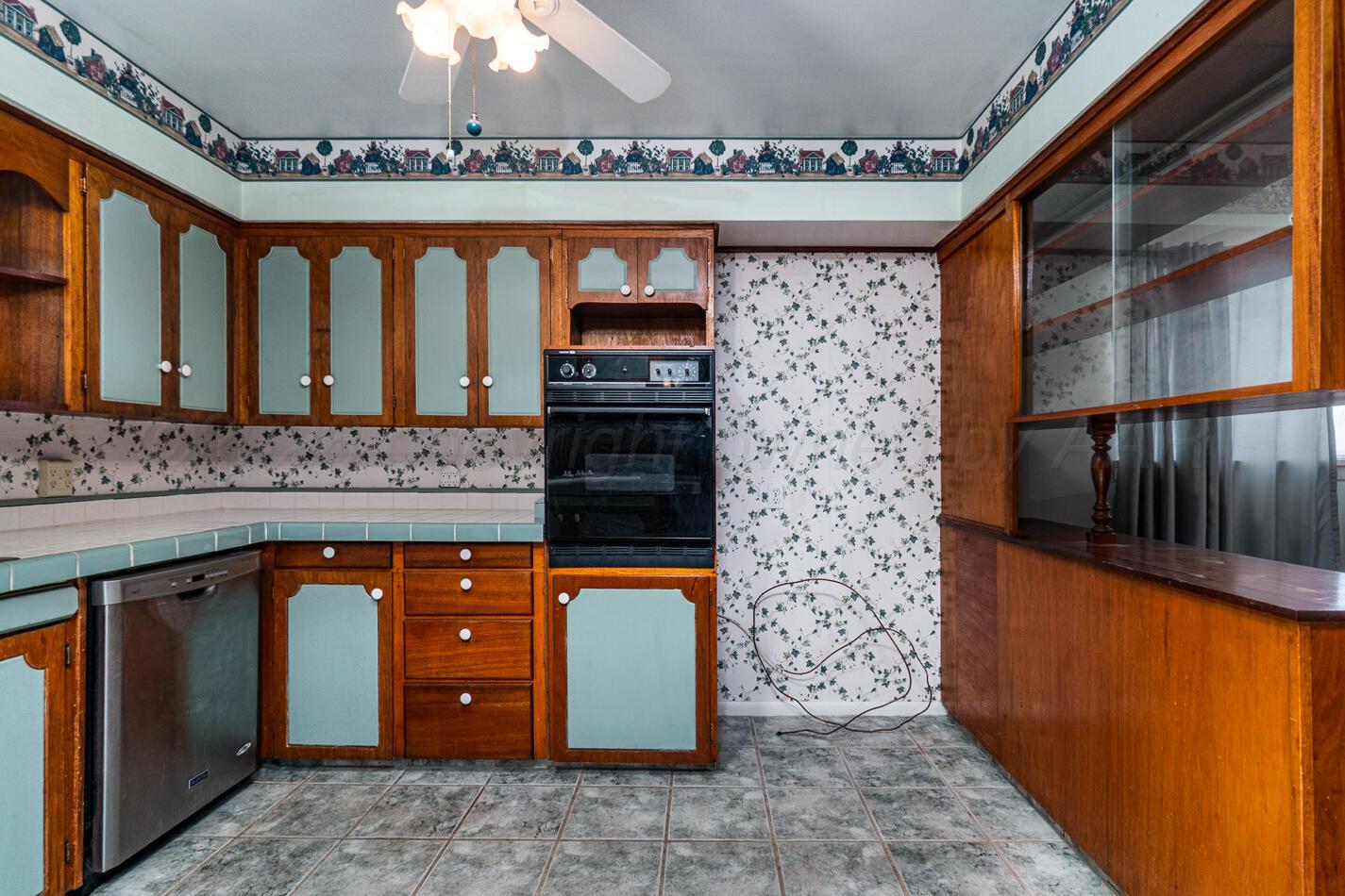 300 Mccarthy Street Borger, TX 79007 - Photo 9 of 31 a kitchen with stainless steel appliances granite countertop a stove a sink and a microwave