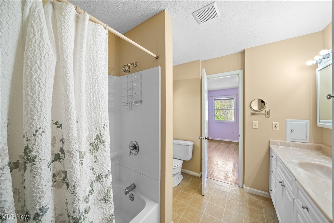 3325 Frantz Road Medina, OH 44256 - Photo 20 of 40 Full bathroom with double vanity, visible vents, baseboards, toilet, and shower / bath combo with shower curtain