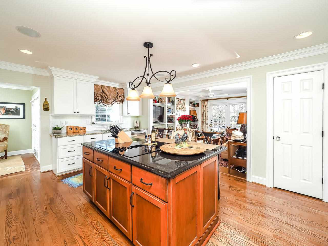 1415 10th Avenue Raleigh, NC 27607 - Photo 8 of 21 a kitchen with stainless steel appliances granite countertop a sink stove and wooden floor
