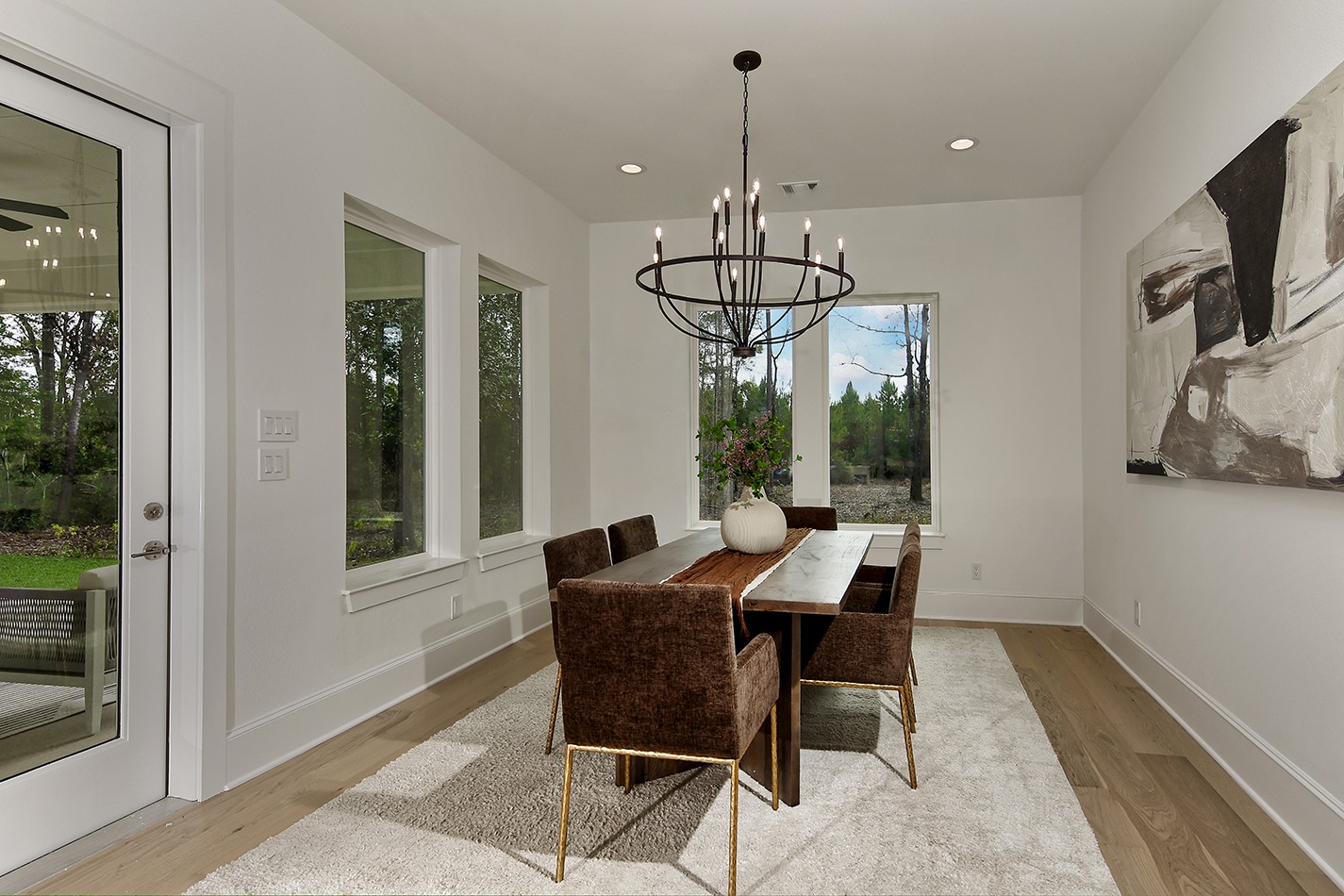 11842 Grand N Road Willis, TX 77378 - Photo 16 of 38 Dining room has an inviting and sophisticated ambiance with stylish chandelier and large windows offering scenic views.