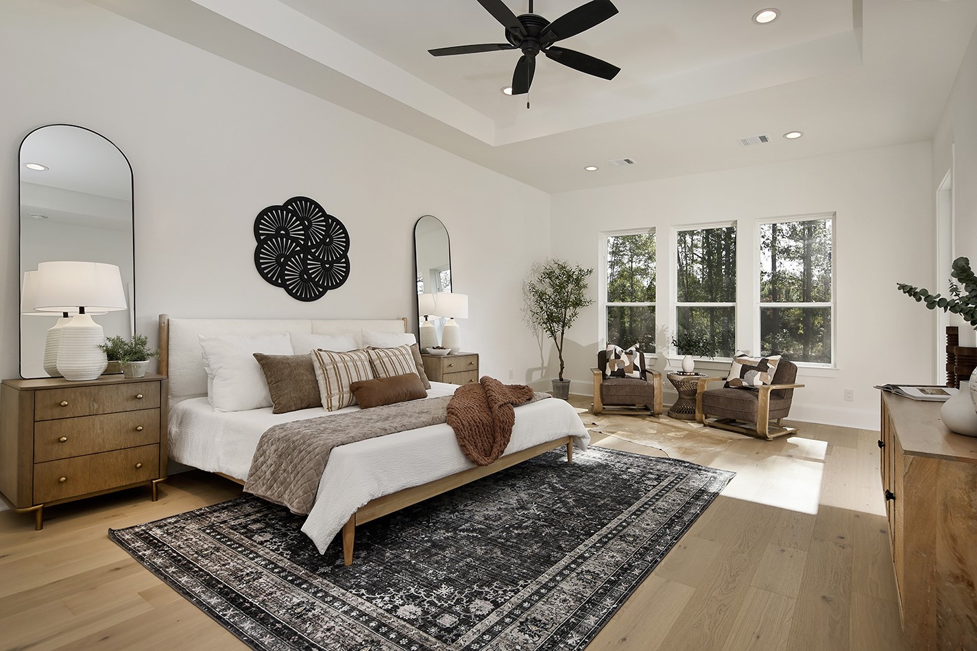 11842 Grand N Road Willis, TX 77378 - Photo 20 of 38 The spacious primary bedroom features a seating area with windows filling room with soft natural lighting. Custom white oak floors add warmth, texture and character.