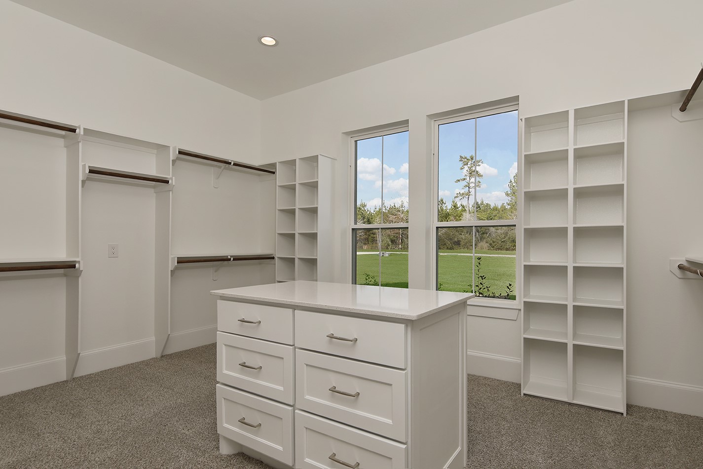 11842 Grand N Road Willis, TX 77378 - Photo 24 of 38 Roomy walk-in custom closet features an abundant amount of shelving, hanging space, and a central island with drawers.