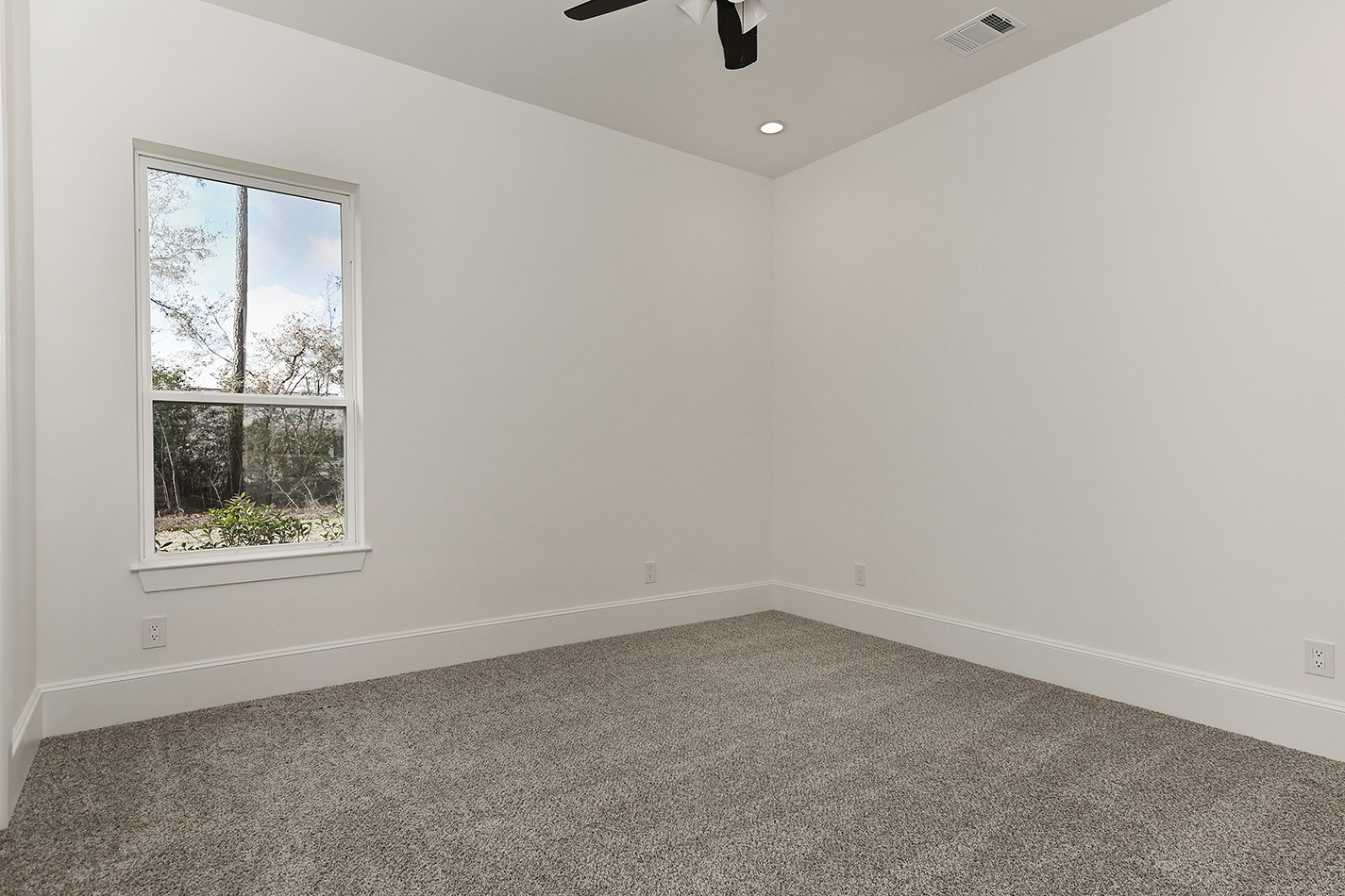 11842 Grand N Road Willis, TX 77378 - Photo 26 of 38 The secondary bedrooms feature plenty of natural light and walk-in closets.
