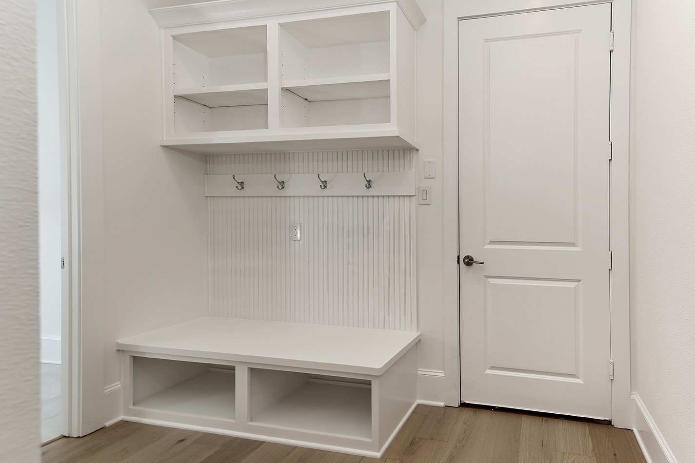 11842 Grand N Road Willis, TX 77378 - Photo 28 of 38 Convenient mudroom built-in bench with storage, open shelving, and hooks for hanging items.