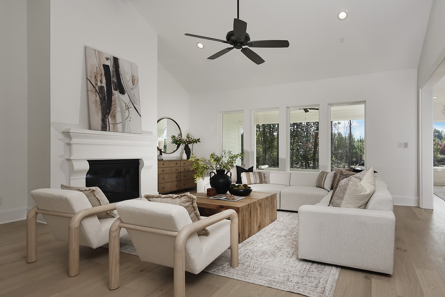 11842 Grand N Road Willis, TX 77378 - Photo 8 of 38 Spacious living room has clean, modern lines with traditional fireplace, and abundant natural lighting from plate glass windows.