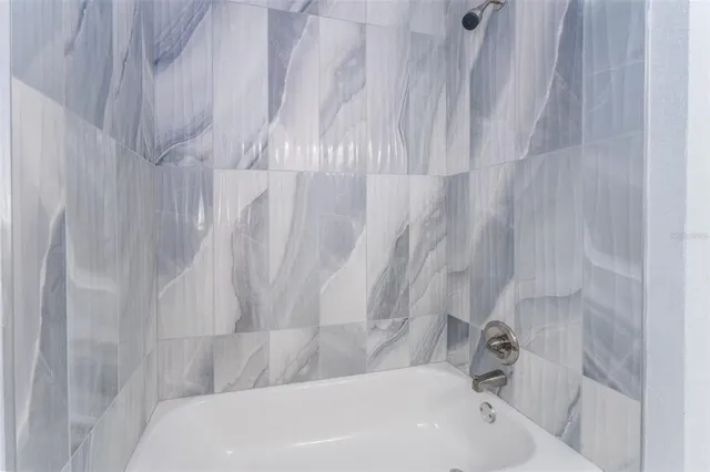 a bathroom with a bathtub and shower