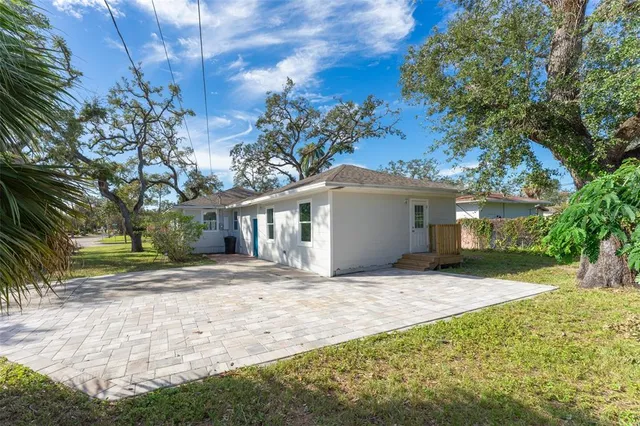 a view of a house with a yard and garage