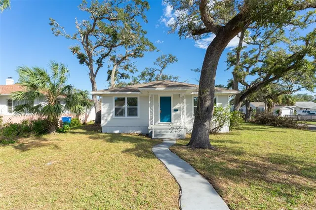 a front view of a house with a garden