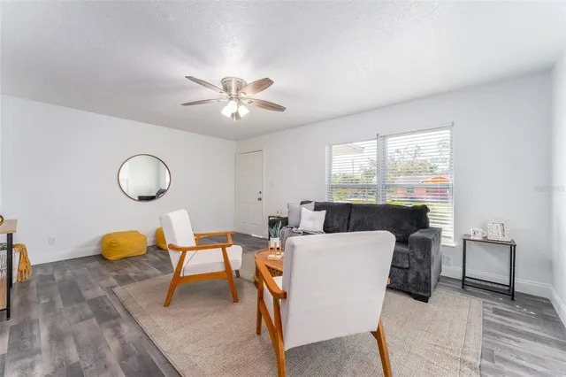 a view of a dining room with furniture a chandelier and wooden floor