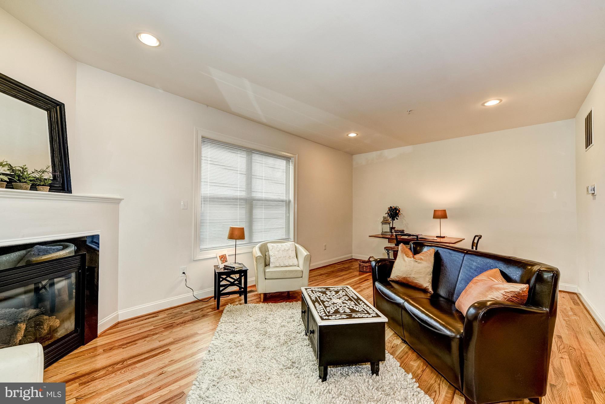 1905 Kermit Road Silver Spring, MD 20910 - Photo 14 of 24 a living room with furniture a fireplace and a table