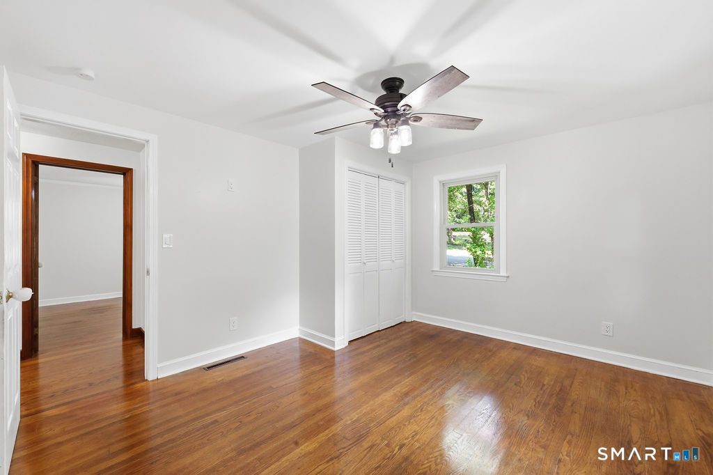 630 South Elm Street Wallingford, CT 06492 - Photo 19 of 30 a view of an empty room with wooden floor and a window