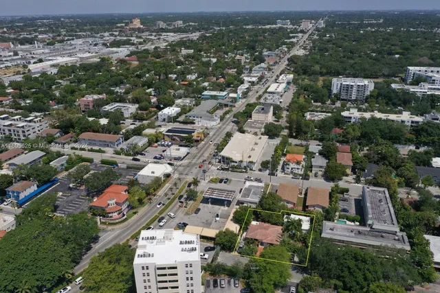 an aerial view of residential houses with city view