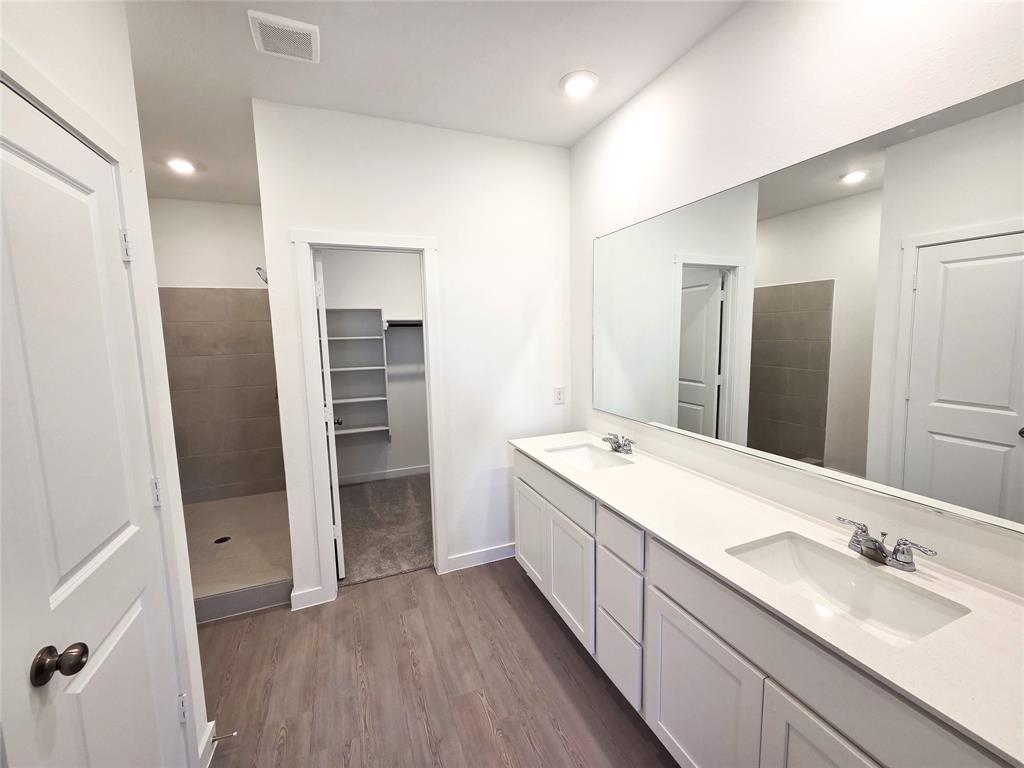 925 Calley Pear Trail Princeton, TX 75407 - Photo 15 of 24 a bathroom with a double vanity sink and mirror