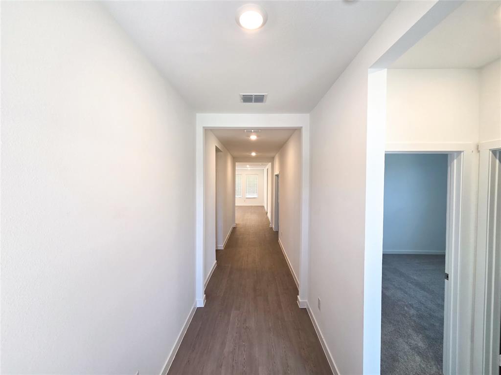 925 Calley Pear Trail Princeton, TX 75407 - Photo 3 of 24 a view of a hallway with wooden floor