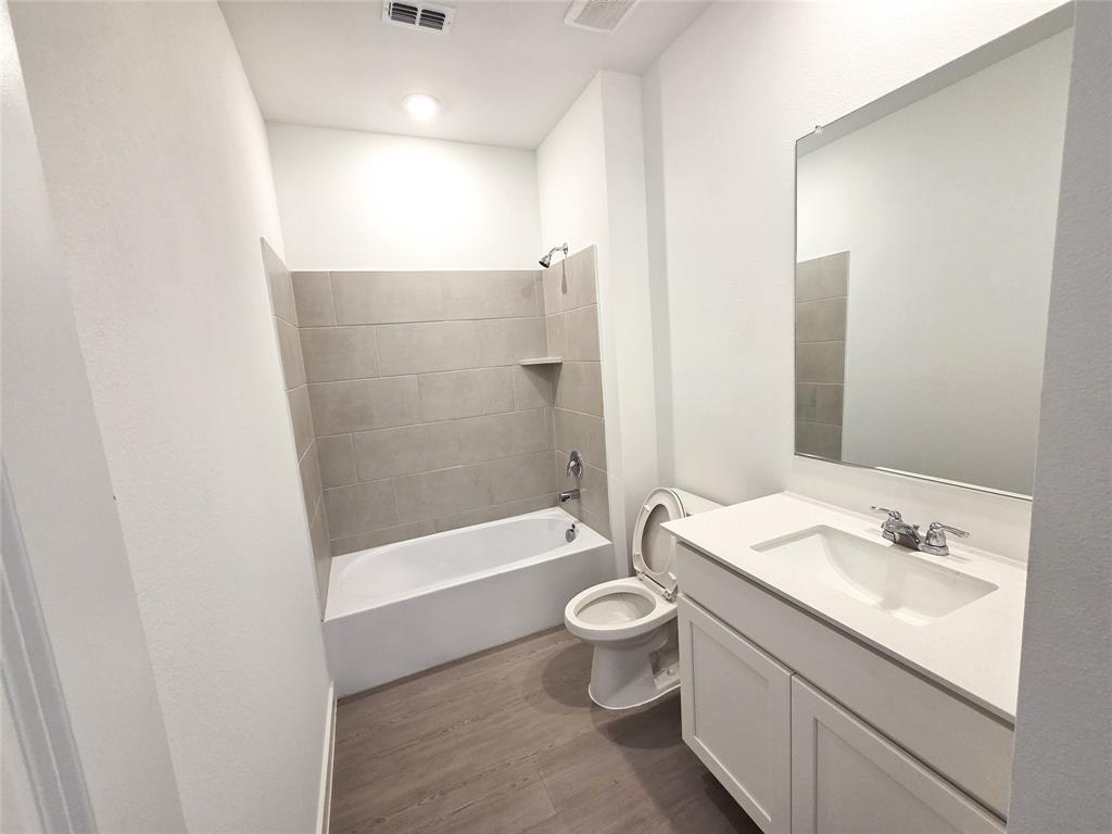 925 Calley Pear Trail Princeton, TX 75407 - Photo 5 of 24 a bathroom with a bathtub shower sink mirror vanity and toilet