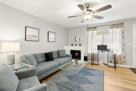 a living room with furniture a fireplace and a table