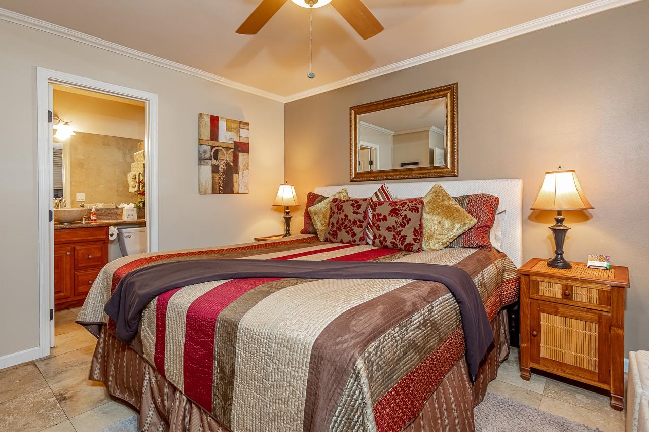 2381 South Kihei Road, Unit B107 Kihei, HI 96753 - Photo 12 of 29 a bedroom with a bed and wooden floor