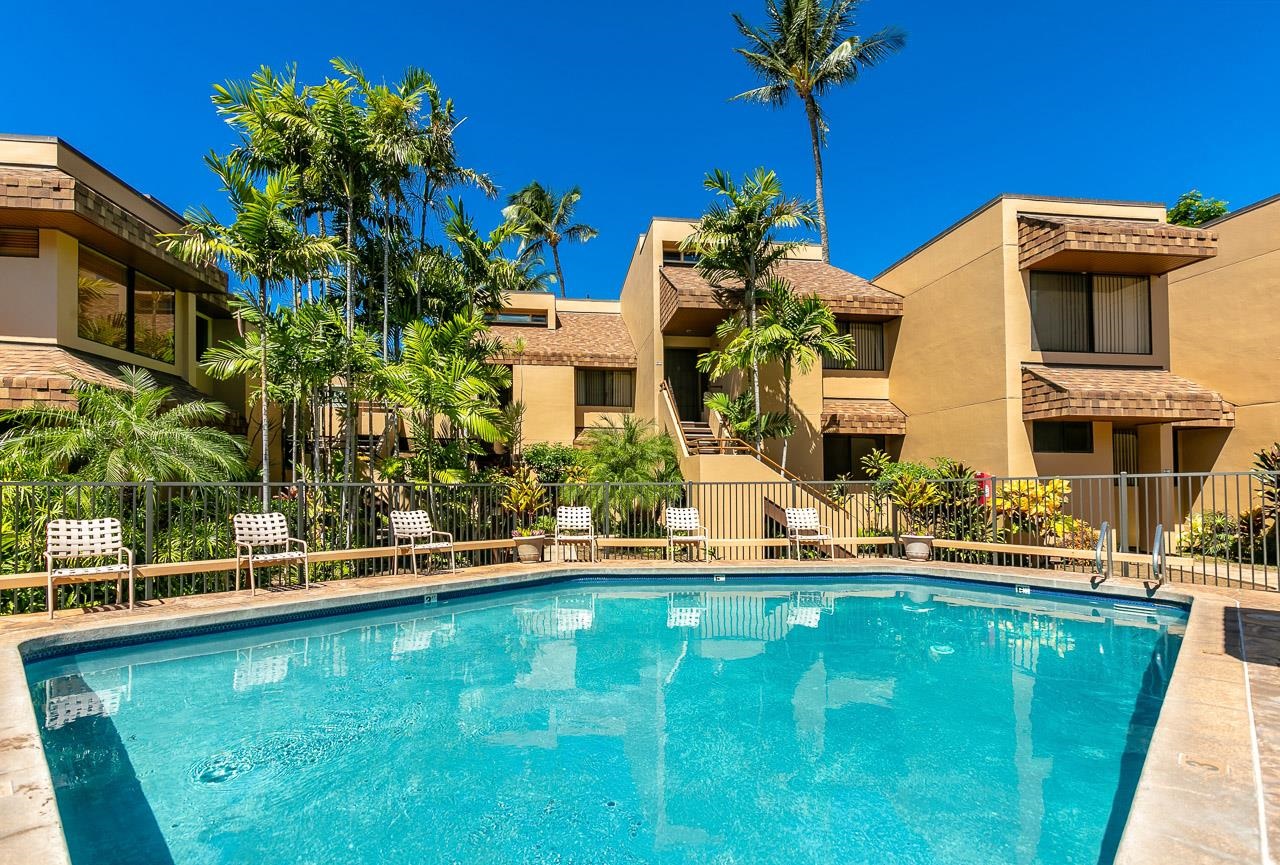 2381 South Kihei Road, Unit B107 Kihei, HI 96753 - Photo 20 of 29 a front view of a house with a yard table and chairs