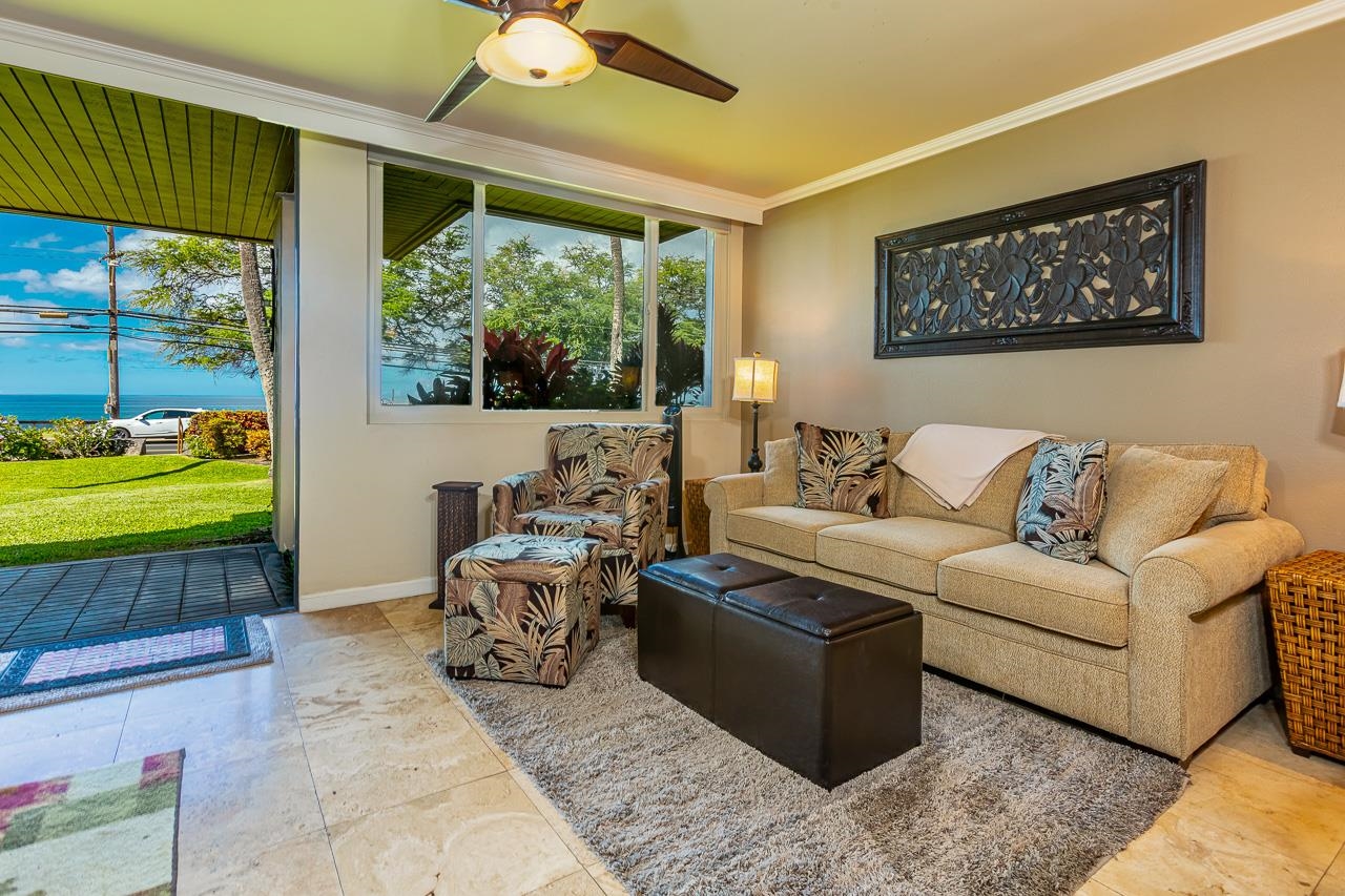 2381 South Kihei Road, Unit B107 Kihei, HI 96753 - Photo 2 of 29 a living room with furniture and a large window