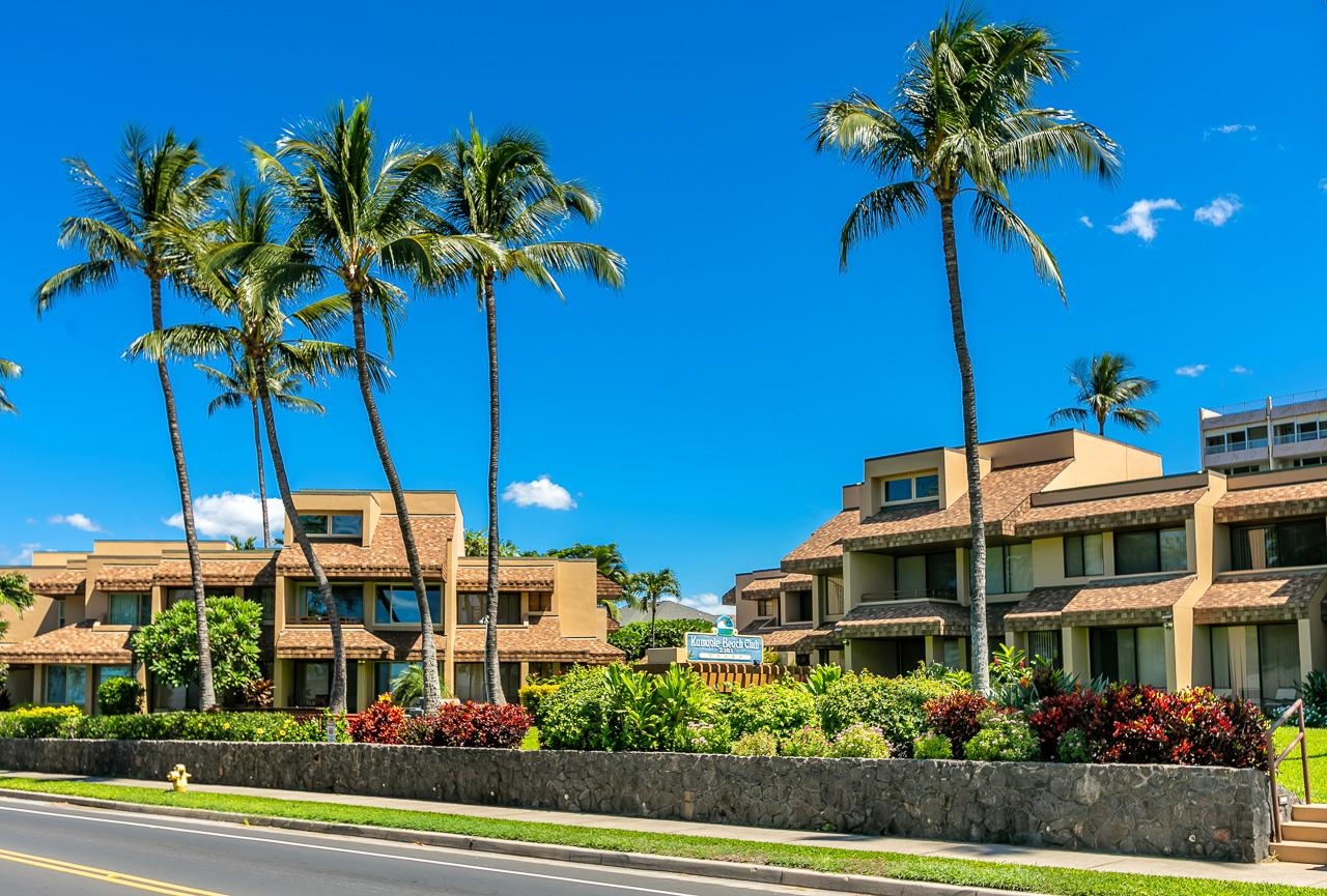 2381 South Kihei Road, Unit B107 Kihei, HI 96753 - Photo 23 of 29 a view of a tall building with a palm tree and a yard