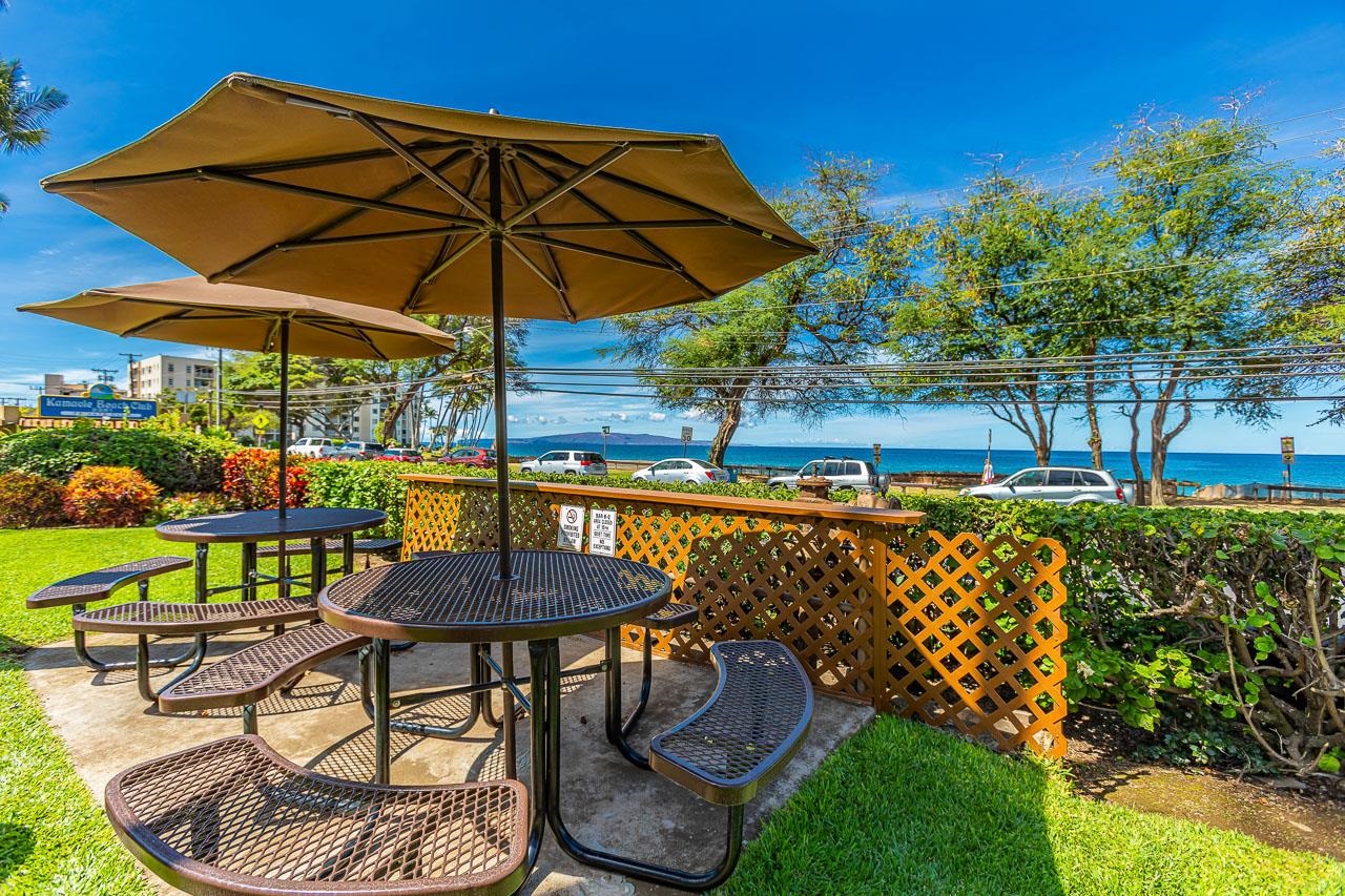 2381 South Kihei Road, Unit B107 Kihei, HI 96753 - Photo 24 of 29 a view of a swimming pool with a table and chairs under an umbrella