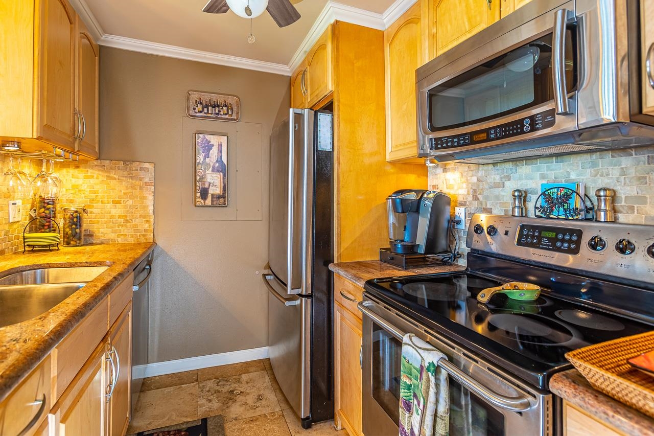 2381 South Kihei Road, Unit B107 Kihei, HI 96753 - Photo 9 of 29 a kitchen with stainless steel appliances granite countertop a stove and a microwave